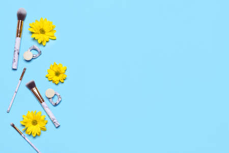 Makeup brushes with earrings on color backgroundの写真素材