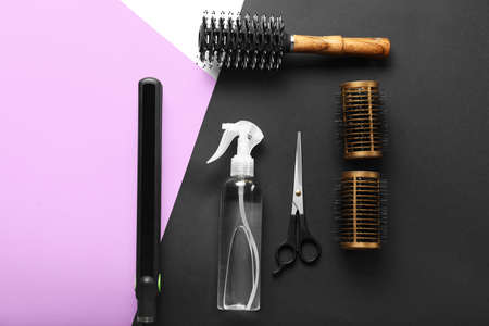 Hair spray with hairdresser supplies on color backgroundの写真素材