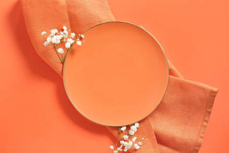 Clean plate and flowers on color backgroundの写真素材