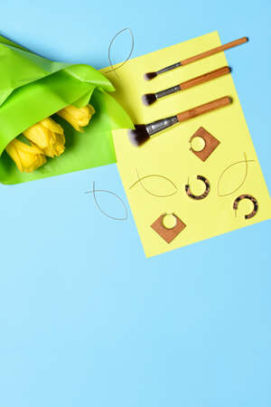 Makeup brushes with earrings on color backgroundの写真素材