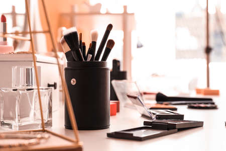 Set of brushes and decorative cosmetics on table of makeup artistの写真素材