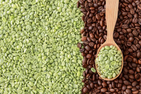 Spoon with roasted and green coffee beansの写真素材