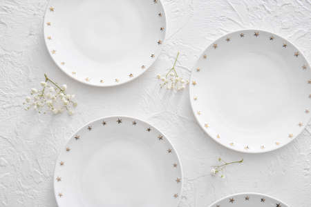 Clean plates and flowers on white backgroundの写真素材