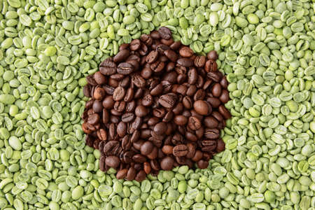 Green and roasted coffee beans as backgroundの写真素材