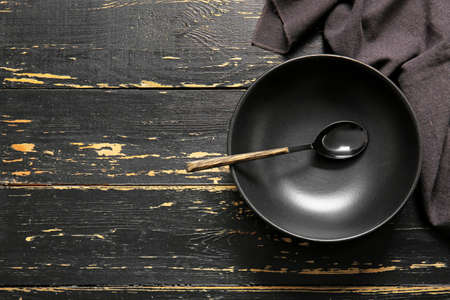 Clean plate and cutlery on dark wooden backgroundの写真素材