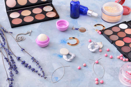 Makeup cosmetics with accessories on color backgroundの写真素材