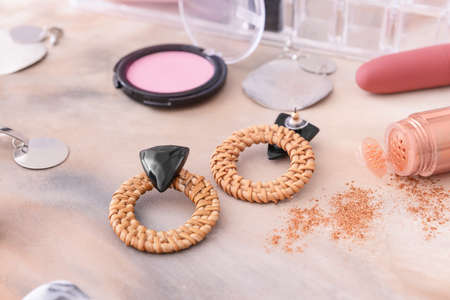 Earrings with makeup cosmetics on gray backgroundの写真素材