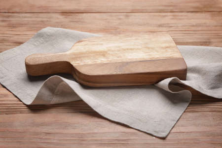 Cutting board with napkin on wooden backgroundの写真素材