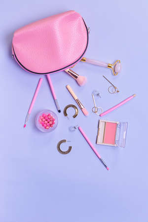 Makeup cosmetics with accessories and bag on color backgroundの写真素材