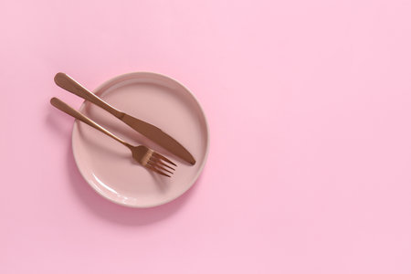 Clean plate and cutlery on color backgroundの写真素材