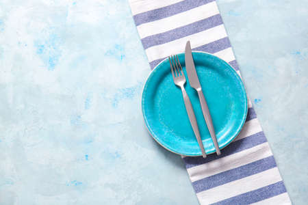 Clean plate and cutlery on color backgroundの写真素材