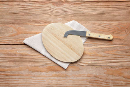 Cutting board with napkin and knife on wooden backgroundの写真素材