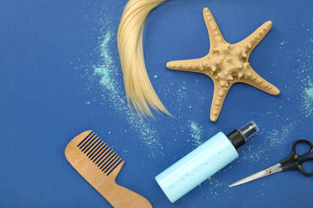 Hair spray with hairdresser supplies and starfish on color backgroundの写真素材