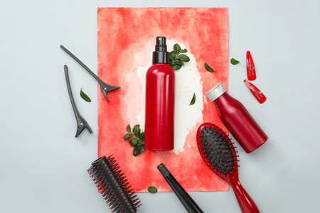 Hair spray with hairdresser supplies on light backgroundの写真素材
