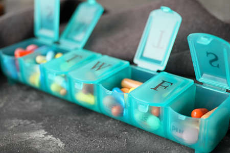 Box with different pills on tableの写真素材