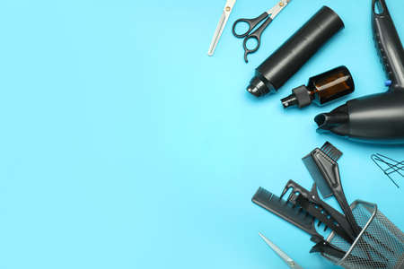 Hair sprays with hairdresser supplies on color backgroundの写真素材