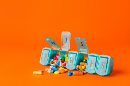 Box with different pills on color backgroundの写真素材
