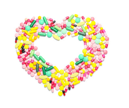 Heart made of pills on white backgroundの写真素材