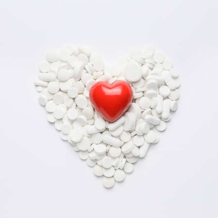 Heart made of pills on white backgroundの写真素材
