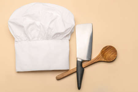 Chef's hat and kitchen utensils on color backgroundの写真素材