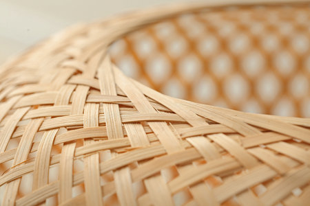 Rattan basket on light background, closeup