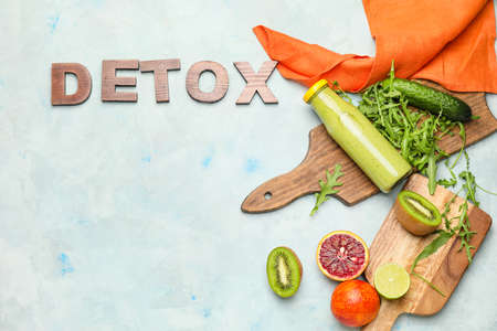 Healthy smoothie with ingredients and word DETOX on tableの写真素材