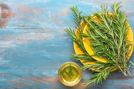 Fresh rosemary and oil on wooden backgroundの写真素材