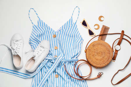 Composition with summer clothes and accessories on light background