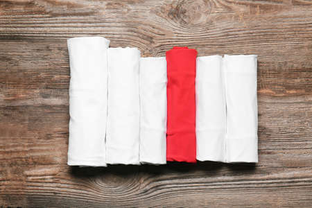 Different stylish t-shirts on wooden backgroundの写真素材