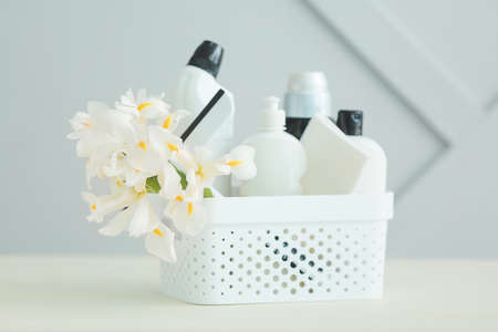 Set of cleaning supplies and spring flowers on gray backgroundの写真素材