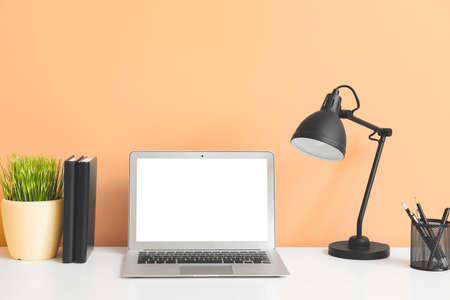 Modern workplace with laptop in room