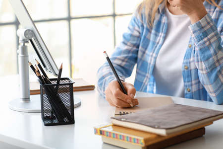 Mature woman using tablet computer for online learning at home
