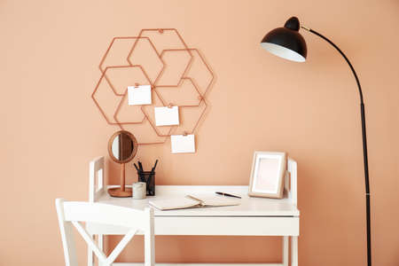 Modern stylish workplace near color wall