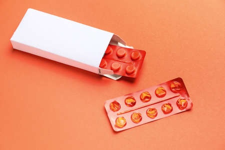 Box with pills on color backgroundの写真素材