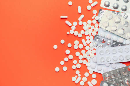 Different pills on color background