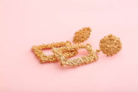 Beautiful earrings on color backgroundの写真素材