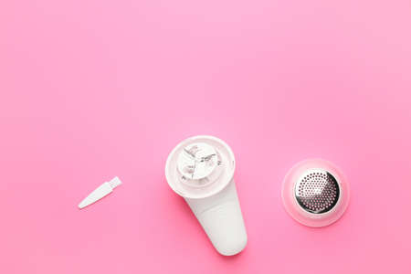 Modern fabric shaver on color backgroundの写真素材