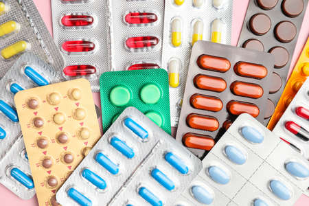 Different pills in blister packs as backgroundの写真素材
