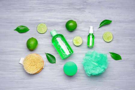 Shower gels with bath supplies on wooden background