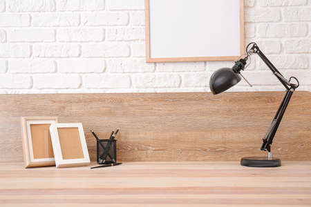 Modern stylish workplace near light wallの写真素材