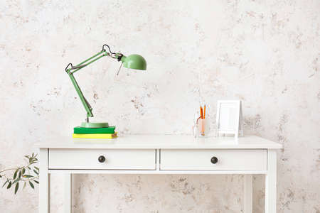 Modern stylish workplace near light wallの写真素材