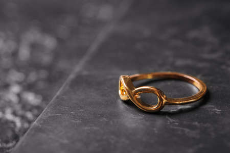 Beautiful golden ring on dark background