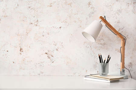 Modern stylish workplace near light wallの写真素材