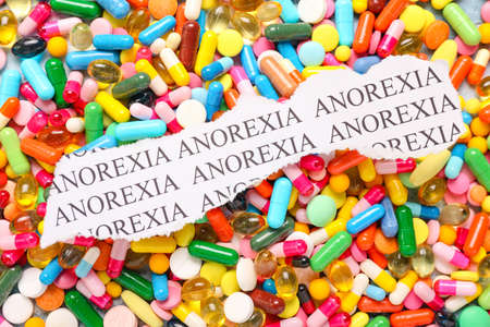 Piece of paper with text ANOREXIA on pillsの写真素材
