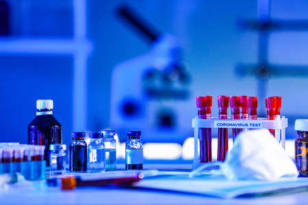 Test tubes with blood samples on table in laboratory. Concept of coronavirus epidemicの写真素材