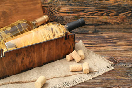 Box with bottles of wine on tableの写真素材