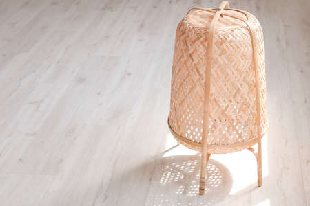 Stylish wicker lantern in roomの写真素材