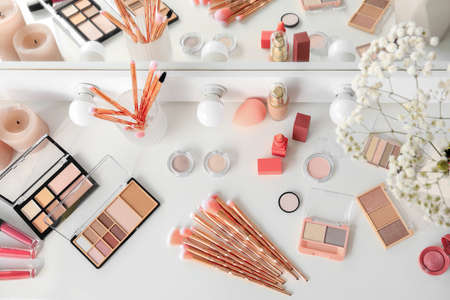 Decorative cosmetics with makeup brushes on dressing tableの写真素材