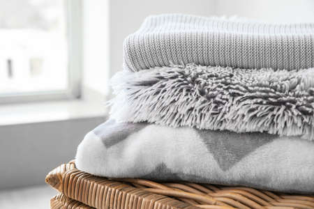 Basket with plaids in room, closeupの写真素材