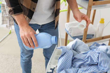 Man doing laundry at homeの写真素材